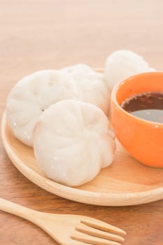 Steamed dumpling stuff on wooden plate, photo