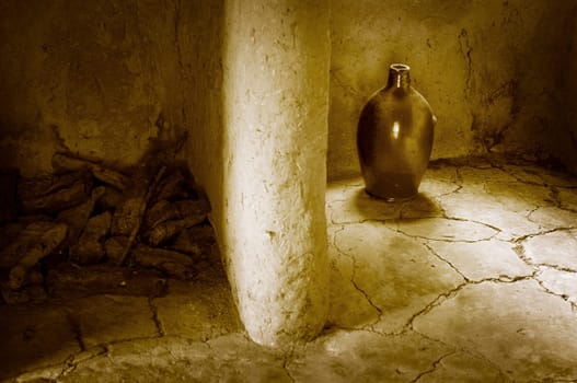 Clay vase in a clay hut with partition to the peat storage monochrome