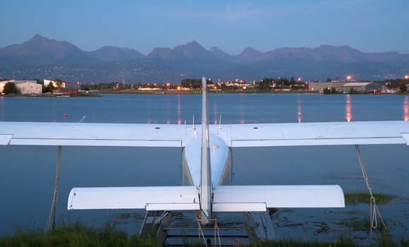 A plane sits waiting for the next chance to be of service as darkness falls on Anchorage