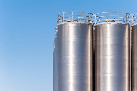 Detail of chemical plant, silos and pipes. Copy space
