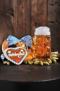 original Bavarian XXL Oktoberfestbreze with beer mug,hops and gingerbread heart on old beer barrel