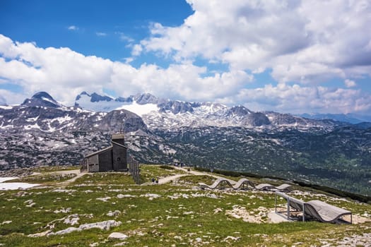Mountain panorama at Dachstein-Krippenstein, wooden lounger, view of chapel