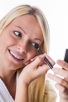 Young woman with Kajal pen in hand