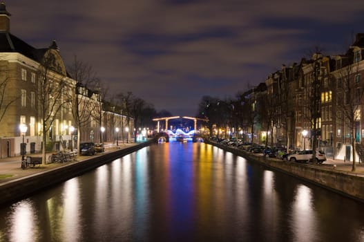 illuminated amsterdam canal and drawbridge at night