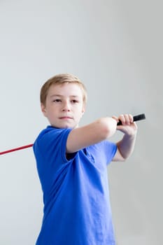 Young boy swinging a golf club