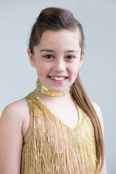 Young girl posing for the camera in her dance costume.