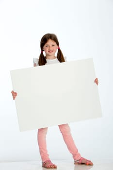 Little girl holding a blank sign against a white background