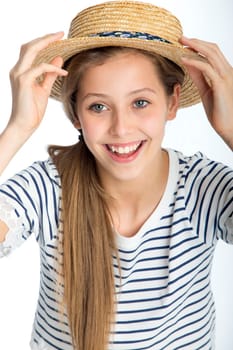 Beautiful girl posing with a straw hat against a white background.