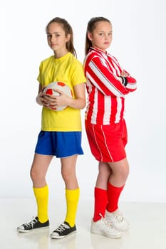 Football team captains looking competitive. They are standing back to back against a white background whilst looking at the camera.