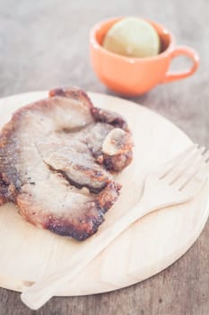 Pork steak on wooden plate, stock photo
