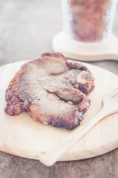 Pork steak on wooden plate, stock photo