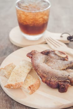 Pork steak on wooden plate, stock photo
