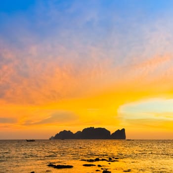 Silhouette of  famous thai Phi-Phi Lee island in colorful romantic sunset. Popular beach holiday travel destination in Thailand, Krabi province.