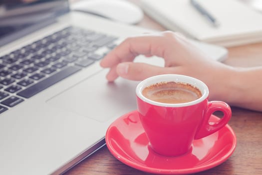 Red coffee cup with notepad and laptop, stock photo