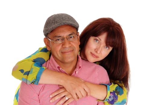 A closeup picture of a happy couple, the Caucasian wife hugging her.Hispanic man from behind, isolated for white background..