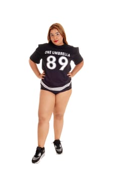 A shabby young East Indian woman in a black top and short pants standing.isolated for white background..