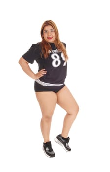 A shabby young East Indian woman in a black top and short pants standing.isolated for white background..
