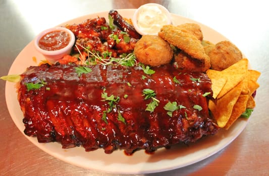 delicious bbq baby-back pork ribs with smokey bbq sauce platter of tortilla chips