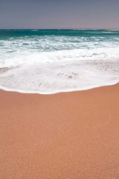 Sea wave and sand on the beach.