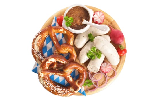 White sausage breakfast with sausages,pretzels and sweet mustard on wooden board