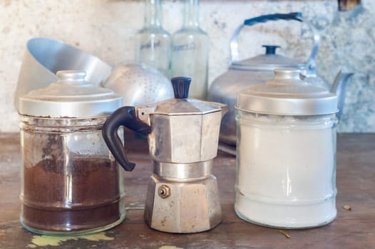 Old coffee maker with two old cans for sugar and coffee