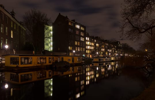houseboat in an amsterdam canal at night