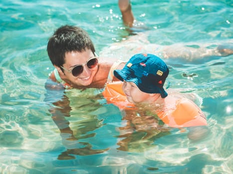 Baby and mother in a sea