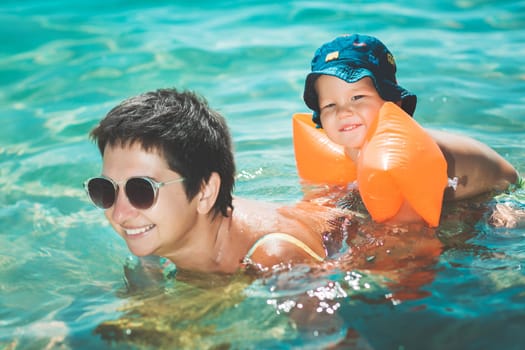 Baby and mother in a sea