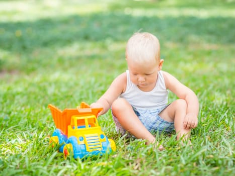 Little boy is playing toy car