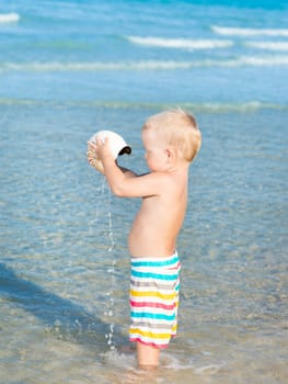 Cute baby plays in a sea