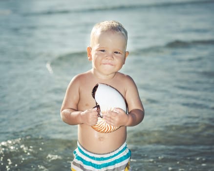 Cute baby plays in a sea