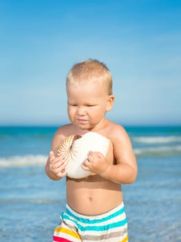 Cute baby plays in a sea