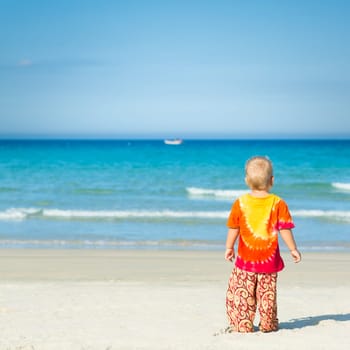 Baby looking sea on the beach