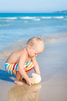 Cute baby plays in a sea