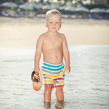 Cute baby plays in a sea