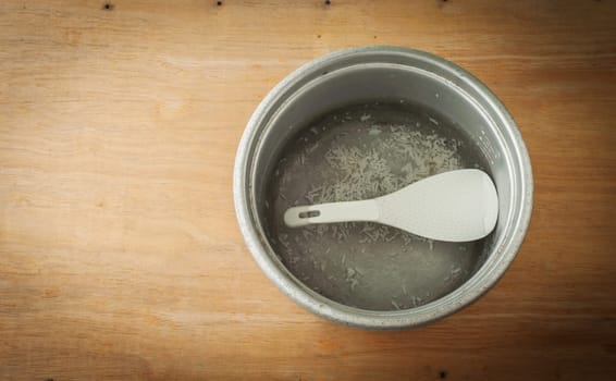 Old aluminium pot on a wooden background, Still life dark border