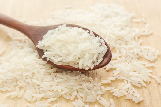 Rice,White rice in wooden spoon on a wood background