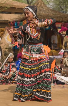 Female Indian Kalbelia dancer from Rajasthan performing at the annual Sarujkund Fair near Delhi in India.