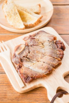 Pork steak on wooden plate, stock photo