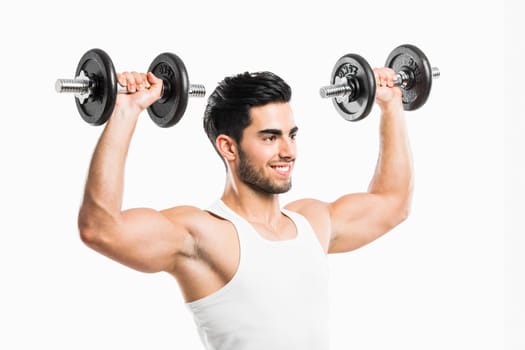Portrait of handsome young man lifting weights, isolated on white background
