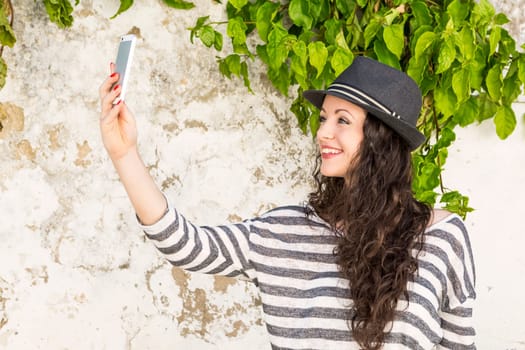 A beautiful young female tourist making a phone call