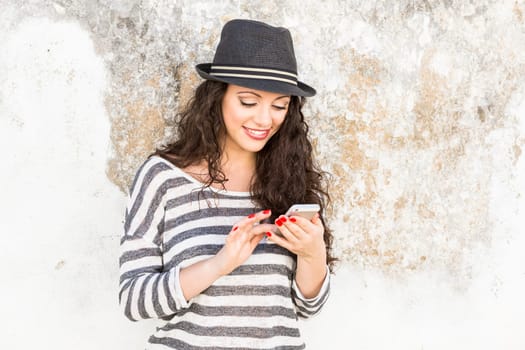 A beautiful young woman sending a text message