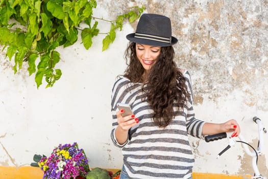 A beautiful young female tourist making a phone call