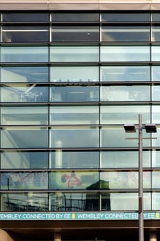 London,UK – November 28,2014: The glass facade of an outlet centre and office building in Wembley Park with an EE banner on 28 November 2014 in London.
