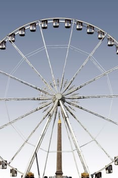 Paris,France – December 29,2013: The Ferris wheel on Place de la Concorde with the obelisk of Luxor in the background on December 29,2013 in Paris.