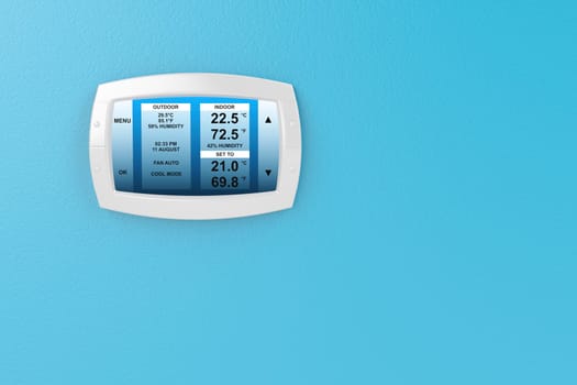Digital thermostat on blue wall