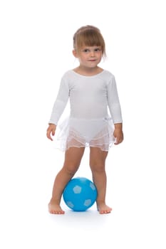 Charming little ballerina with a blue ball in the studio. Isolate on white.