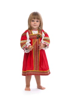 Little girl in red traditional dress with a wooden spoon. Isolate on white.