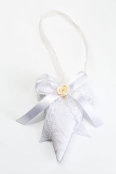 Knit handmade heart on a light gray background.