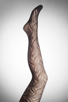 Mannequin female foot in stylish fashion pantyhose.